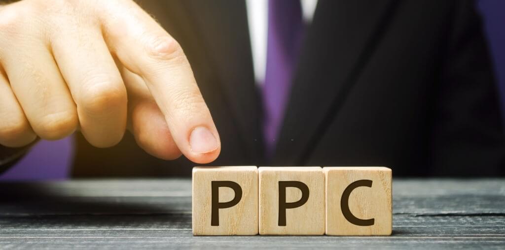 Businessman touching wooden blocks that say PPC
